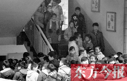 　某小學(xué)的學(xué)生走下樓梯放學(xué)。