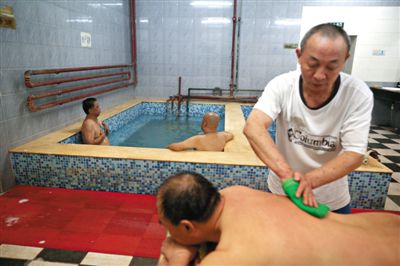 客人在搓澡。近日，百年歷史的鑫園浴池宣布將關(guān)張。新京報(bào)記者