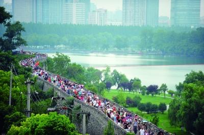 　　昨天,數(shù)萬南京市民參加“環(huán)城七十里”徒步走,圖為解放門城墻上密集的人群。 本版攝影 實習(xí)生 王甜