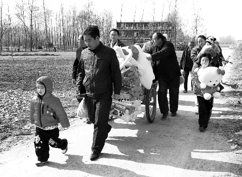 姐（左一）弟（右一護(hù)士懷中男嬰）返鄉(xiāng)，愛心捐贈(zèng)滿滿一架子車。